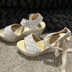 Wedged heels. Never worn.